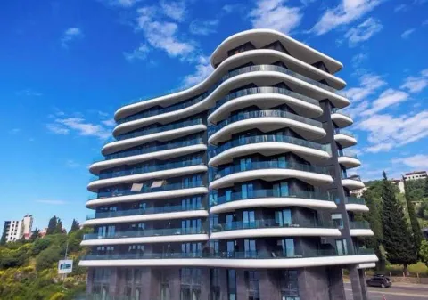 Exterior of a modern multi-story residential building with terraces. - image 9