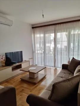 Living room with sofa, TV, and access to the terrace. - image 2