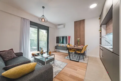 Living room with dining area and kitchen, and access to the terrace. - image 2