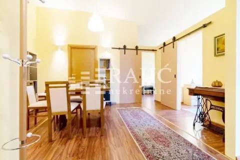 Spacious living room with a dining area and wooden flooring. - image 7