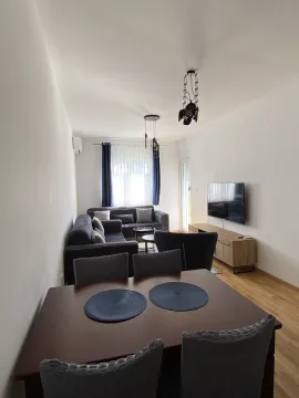 Bright living room featuring a dining table and sofa seating. - image 12