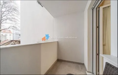 Smaller covered balcony area with ceramic tiles and a view of surrounding buildings. - image 14