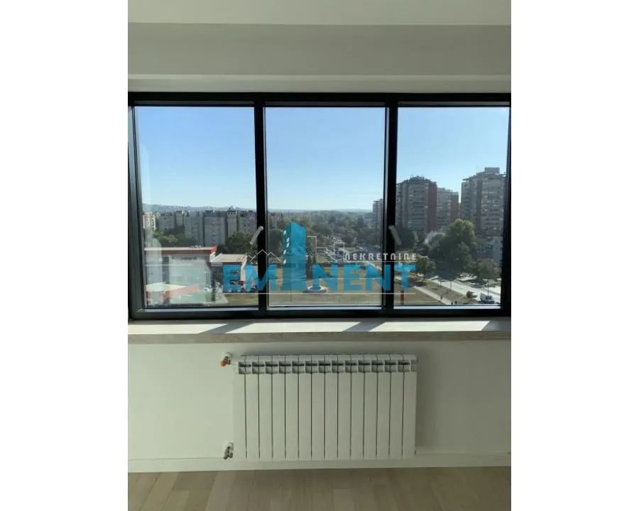 View of the city neighborhood through a large window.