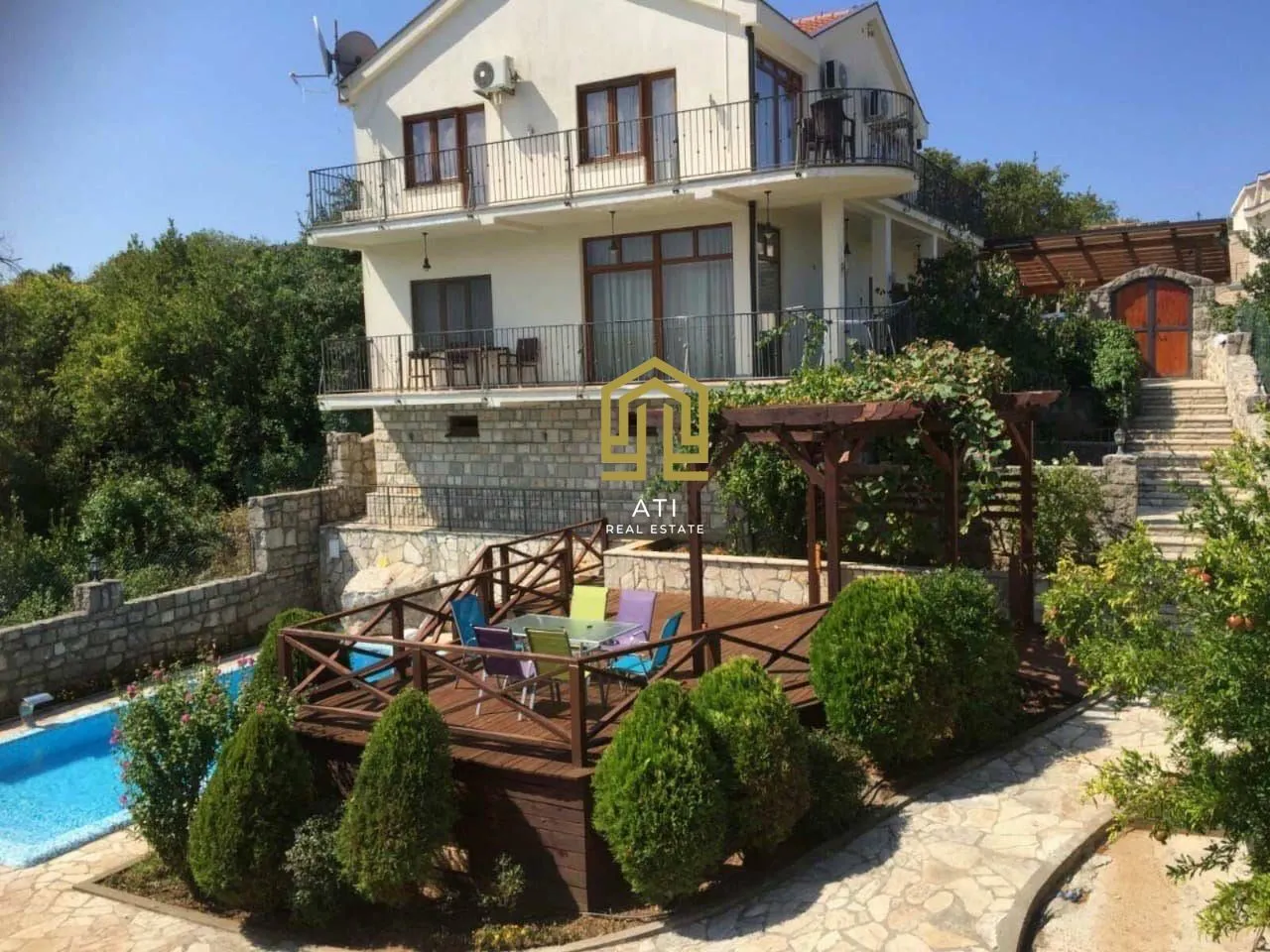 Exterior of the house with a swimming pool, terrace, and landscaped yard.