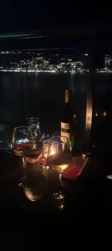 Noćni pogled sa terase na osvijetljeni grad i more. - image 16