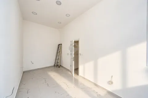 Empty bright room with tiled flooring and an open door. - image 6