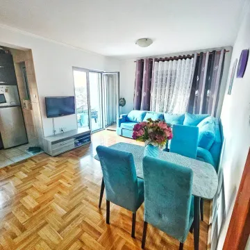 Living room with a sofa set, dining table, and access to the terrace. - image 9