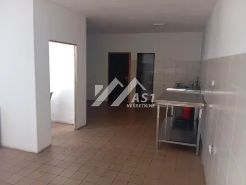 Empty kitchen with tiled floor and work units. - image 4