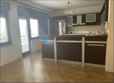 Kitchen with dark cabinetry, a breakfast bar, and a dining area. - image 4
