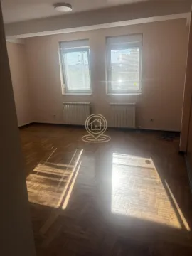 Empty room with parquet flooring and two windows. - image 5