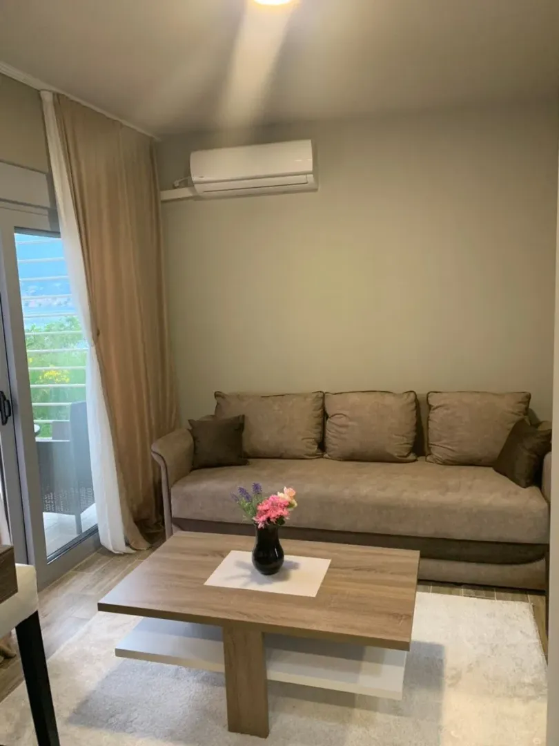 Living room with a sofa, coffee table, and access to the terrace.