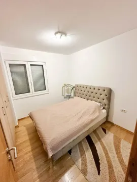 Furnished bedroom with a double bed, wardrobe, and a window. - image 7