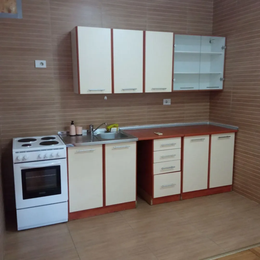 Kitchen with white cabinets and an electric stove.