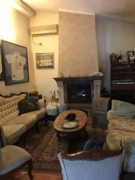 Living room with a fireplace, seating area, and a coffee table. - image 15