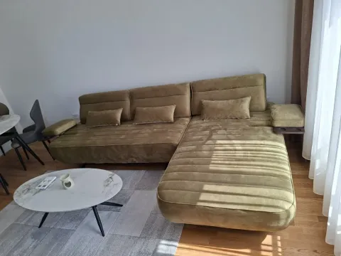 Bright living room featuring a comfortable sectional sofa and a coffee table. - image 3
