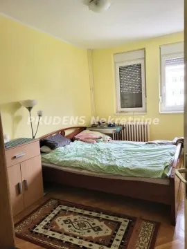 Furnished bedroom with a double bed, cabinet, and two windows. - image 5