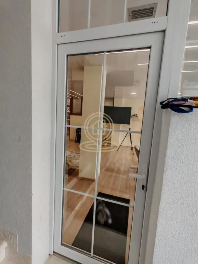 View through the glass door into the interior of the property.