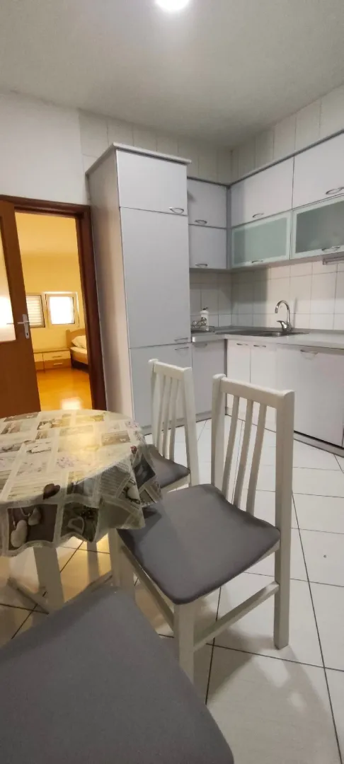 Small kitchen with a dining table and chairs.