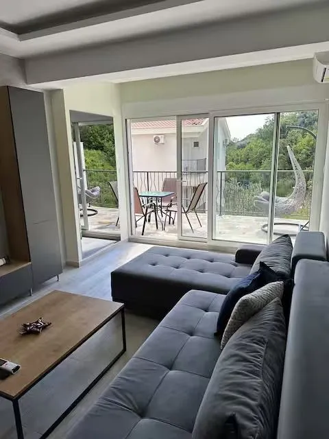 Living room with a sofa and access to the terrace.