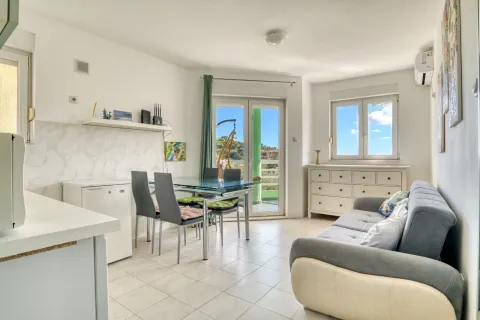 Living room with a sofa, dining area, and access to the terrace. - image 3