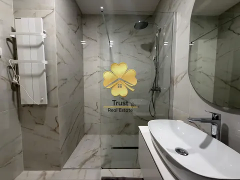 Modern bathroom with a shower cabin and a washbasin. - image 8