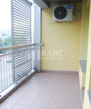 Covered balcony with ceramic tiles and metal railing. - image 7