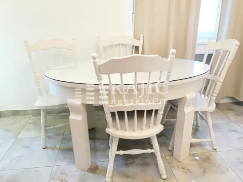Dining table with white wooden chairs. - image 11