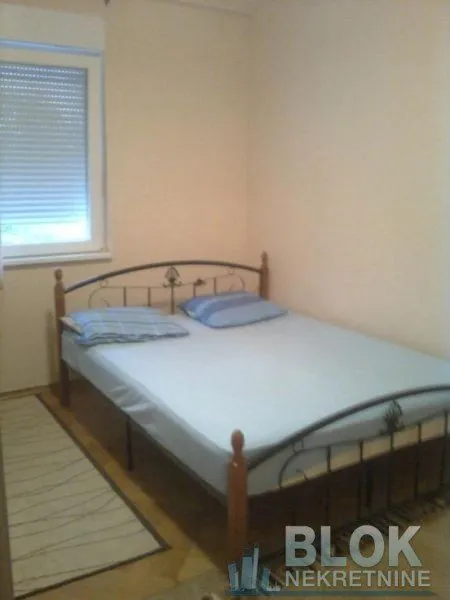 Bedroom with a double bed and a window.