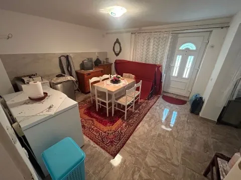 Living room with a dining table and a door leading outside. - image 14