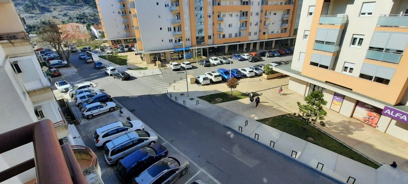 View from the terrace overlooking the street and parking lot in front of the building.