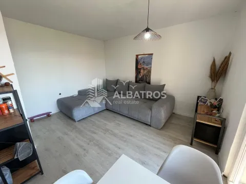 Living room with a corner sofa and a dining table. - image 2