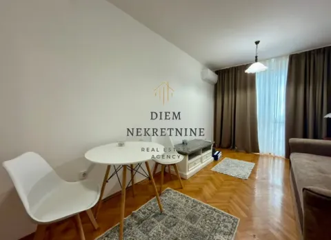 Living room with a dining table, sofa, and parquet flooring. - image 4