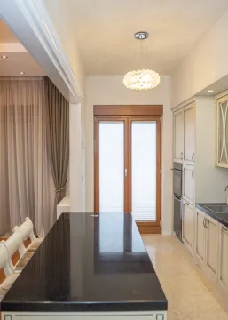 Modern kitchen with a dark countertop and built-in units. - image 6