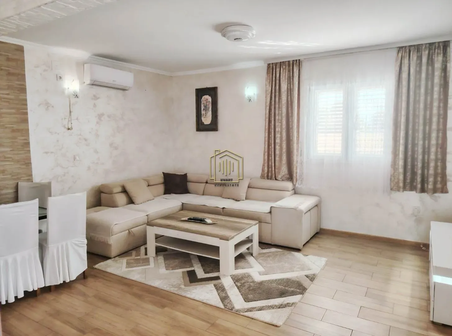 Living room with a sectional sofa, coffee table, and dining area.