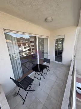 Covered balcony with patio furniture and a view of the surroundings. - image 3