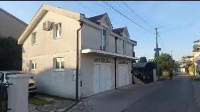 Exterior view of a two-story house with a garage along the street. - image 4