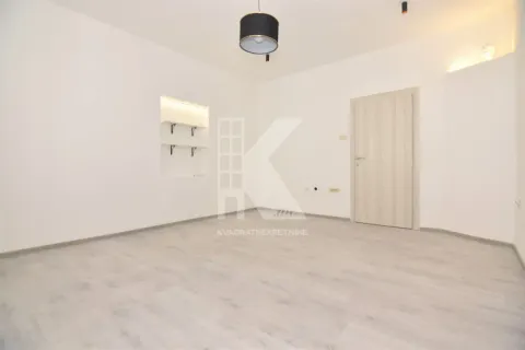 Empty bright room with white walls, laminate flooring and a wooden door. - image 3