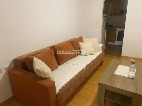Living room with a brown sofa and a wooden coffee table. - image 3
