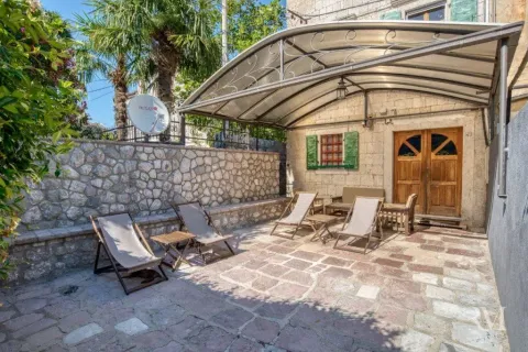 Paved courtyard with a canopy and sun loungers in front of the house. - image 6