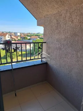 Small tiled balcony with a metal railing and a view of the neighborhood. - image 9