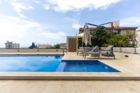 Roof swimming pool with sun loungers and surrounding views. - image 5