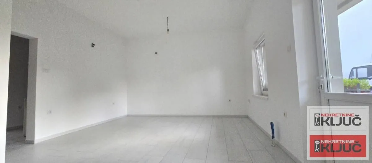Empty unfurnished room with white walls and a window.