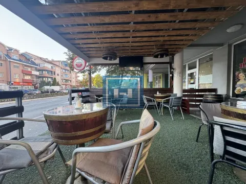 Covered terrace of a catering establishment with tables and chairs by the street. - image 11