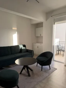 Living room with a sofa, coffee table, and access to the terrace. - image 2