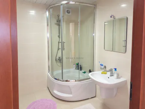 Bathroom with a shower cabin, washbasin, and mirror. - image 8