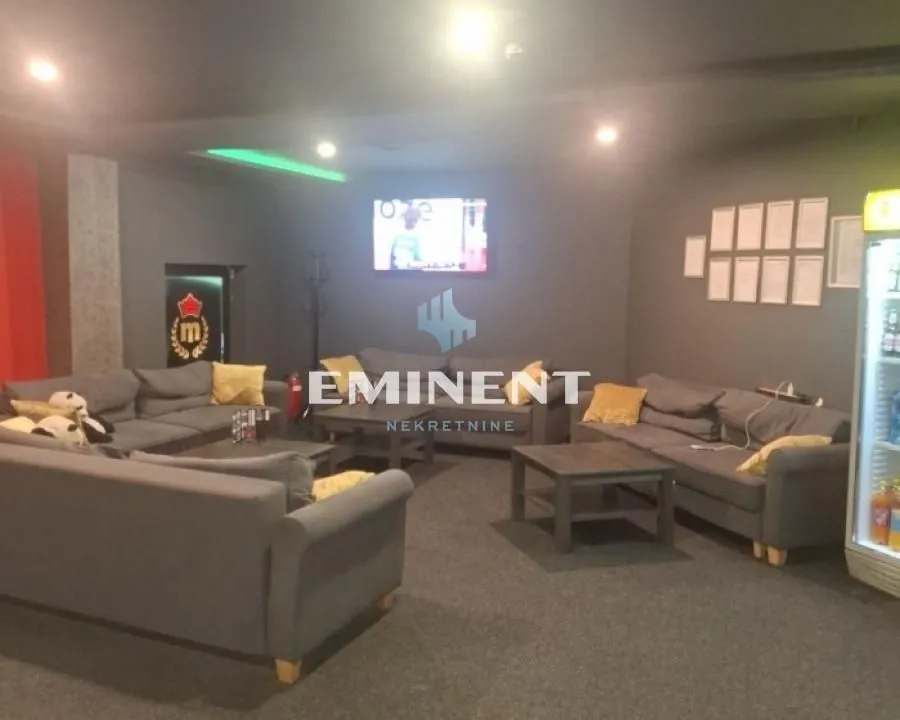 Spacious living room furnished with seating sets and coffee tables.