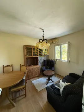 Living room with a dining table, seating furniture, and wooden cabinetry. - image 4