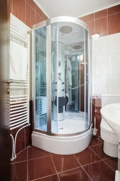 Bathroom with a shower cabin, sink, and toilet. - image 19