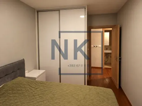 Bedroom with a double bed, built-in wardrobe, and a view of the bathroom. - image 8