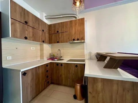 Modern kitchen with wooden elements and a bar counter. - image 4